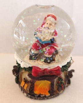 Santa Claus snow globe with book