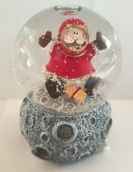Snow globe Santa Claus on the moon with gift