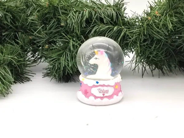 Unicorn snow globe with a pink base